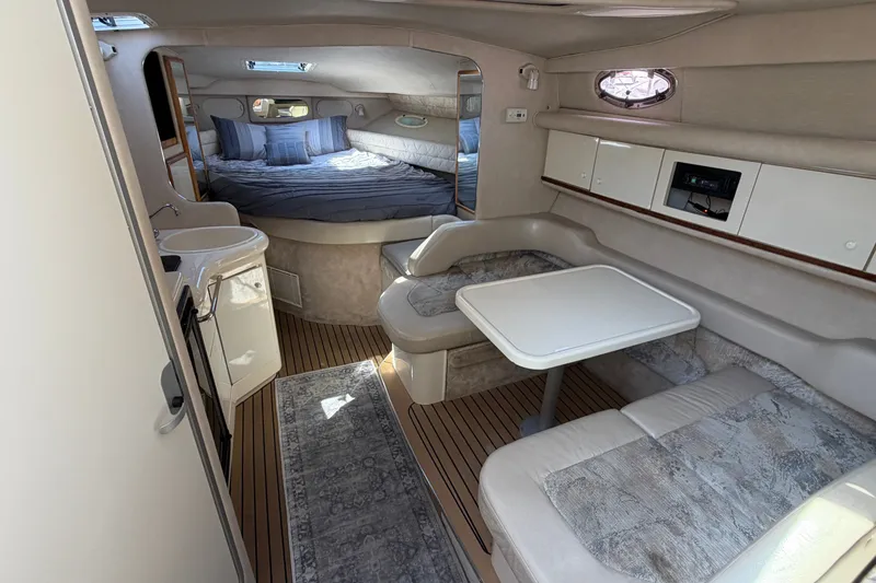 Slide: The Image of Interior of a 1996 Sea Ray Sundancer 330 yacht with cozy seating and sleeping area. - 27
