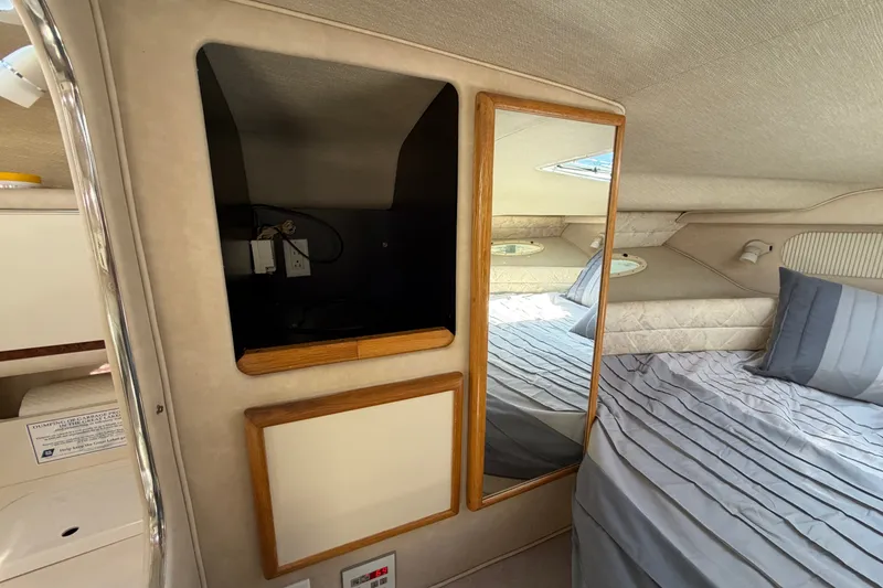 Slide: The Image of Interior cabin of 1996 Sea Ray Sundancer 330 with bed and storage compartments. - 37