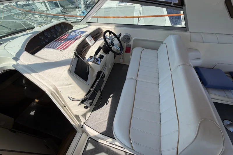 Slide: The Image of 1996 Sea Ray Sundancer 330 cockpit with white seating and control panel. - 16
