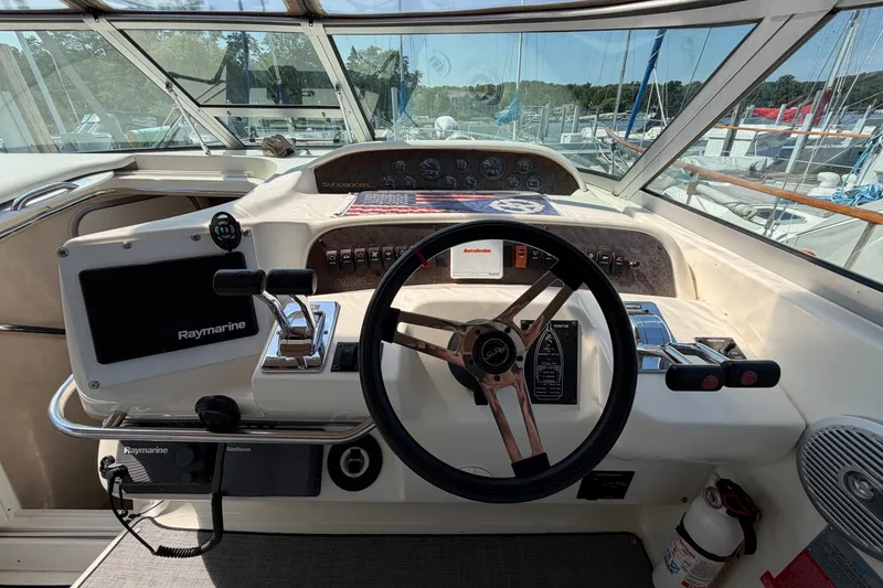 Slide: The Image of 1996 Sea Ray Sundancer 330 helm with Raymarine electronics and classic steering wheel. - 13