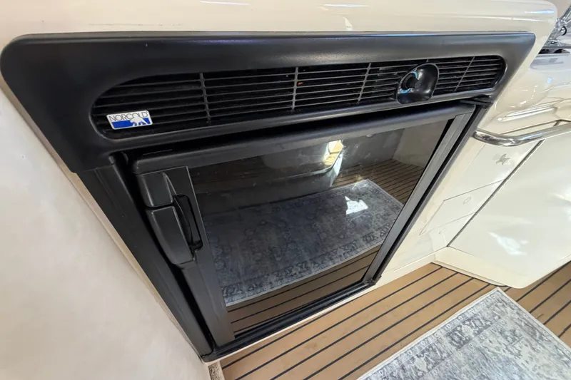 Slide: The Image of Norcold refrigerator inside 1996 Sea Ray Sundancer 330 yacht, featuring sleek black design. - 34