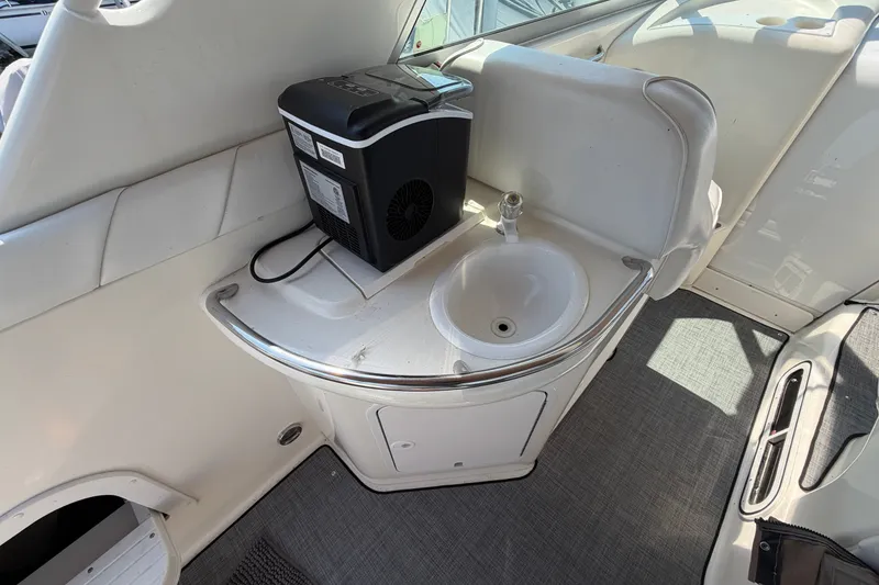 Slide: The Image of 1996 Sea Ray Sundancer 330 interior with sink and appliance on white counter. - 18