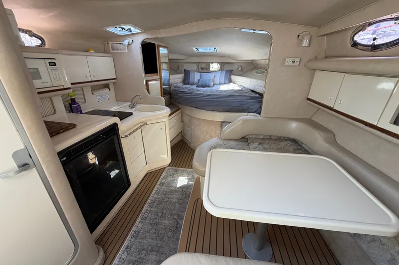 Slide: The Image of Interior of 1996 Sea Ray Sundancer 330 yacht with kitchen, dining area, and sleeping quarters. - 25