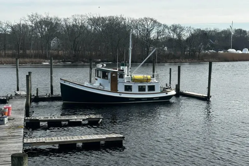 The Image of 1983 Lord Nelson Victory Tug/Trawler docked on a calm river. - 0