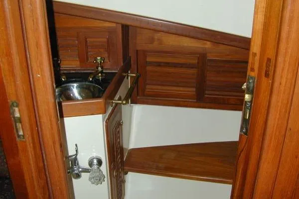 Slide: The Image of 1983 Lord Nelson Victory Tug interior with wooden cabinetry and compact sink. - 17