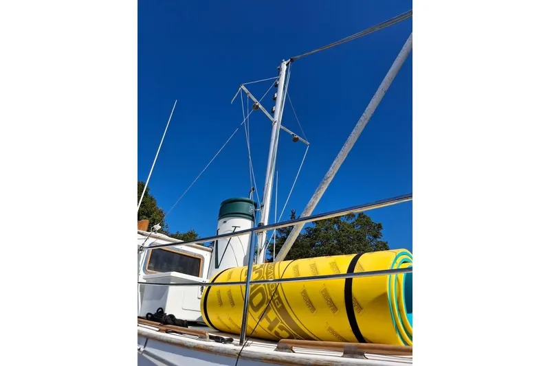Slide: The Image of 1983 Lord Nelson Victory Tug/Trawler with yellow equipment on deck under clear blue sky. - 25
