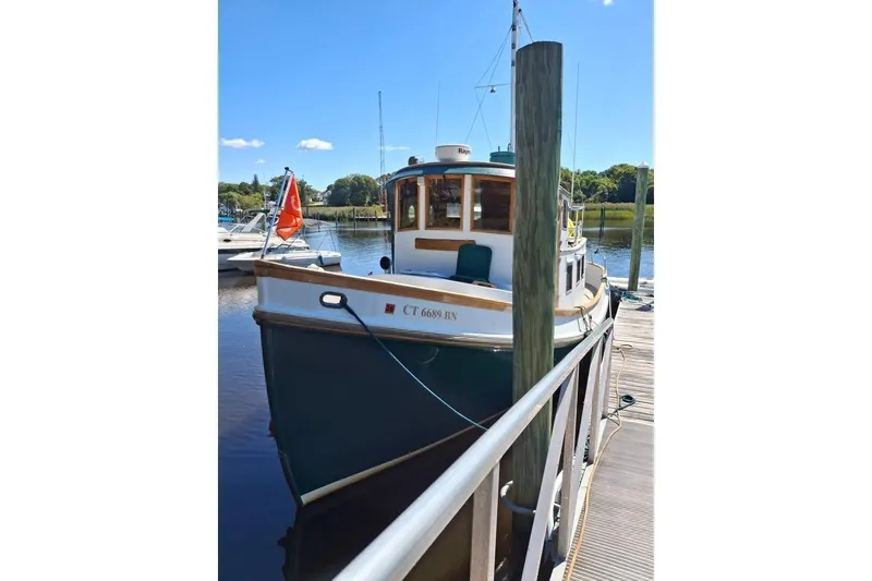 Slide: The Image of 1983 Lord Nelson Victory Tug/Trawler docked at marina on a sunny day. - 26