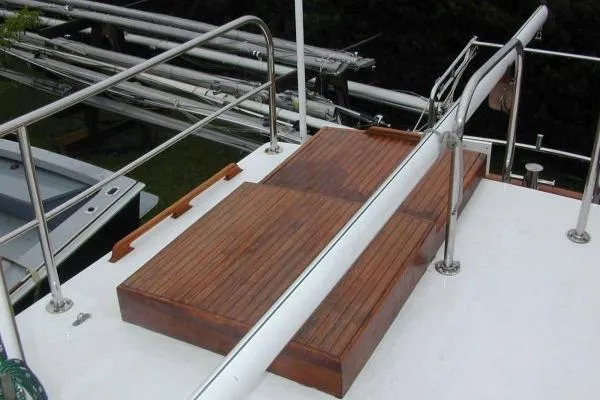 Slide: The Image of 1983 Lord Nelson Victory Tug/Trawler deck with wooden steps and metal railings. - 29