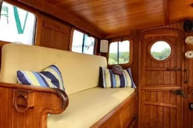 Slide: The Image of 1983 Lord Nelson Victory Tug interior with wooden finish and striped cushions. - 35
