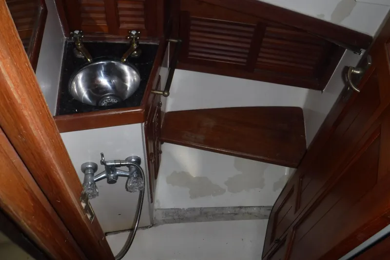 Slide: The Image of 1983 Lord Nelson Victory Tug bathroom with wooden accents and stainless steel sink. - 38