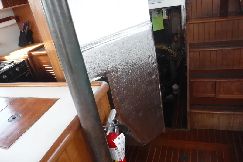 Slide: The Image of Interior of 1983 Lord Nelson Victory Tug, featuring kitchen and engine access. - 48