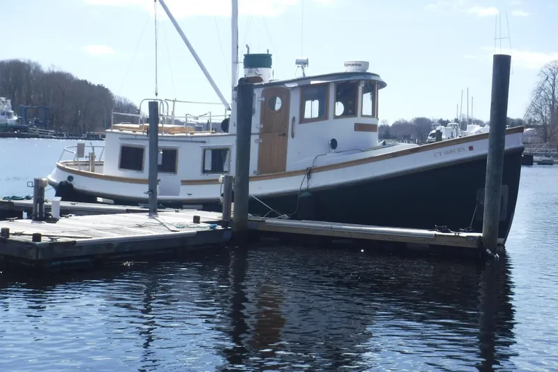 Slide: The Image of 1983 Lord Nelson Victory Tug/Trawler moored at a dock on a calm waterway. - 53