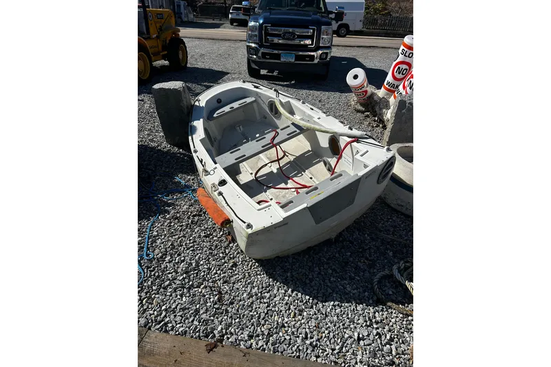 Slide: The Image of 1983 Lord Nelson Victory Tug/Trawler boat on gravel, with vehicles and signs nearby. - 55