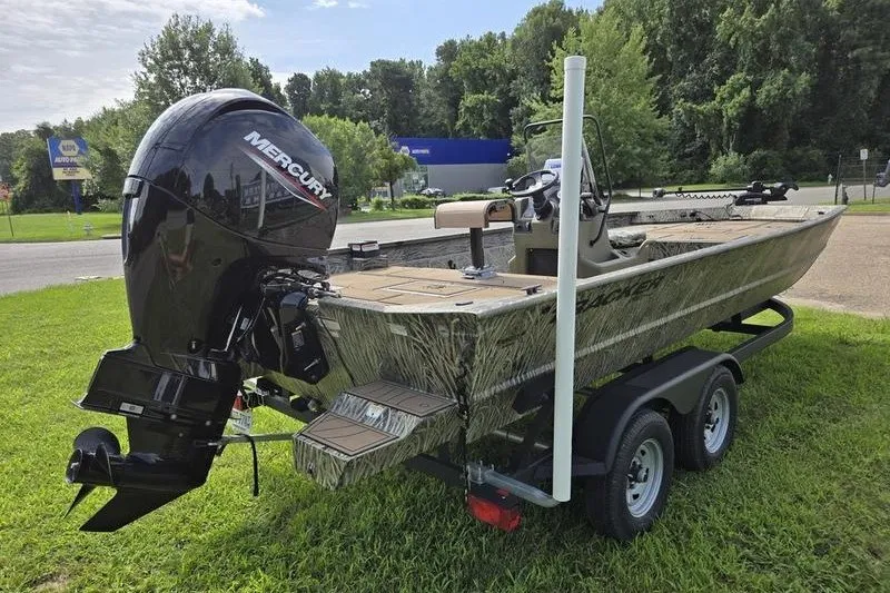 Slide: The Image of 2025 Tracker Grizzly 2072 CC boat with Mercury engine on trailer, parked on grass. - 8