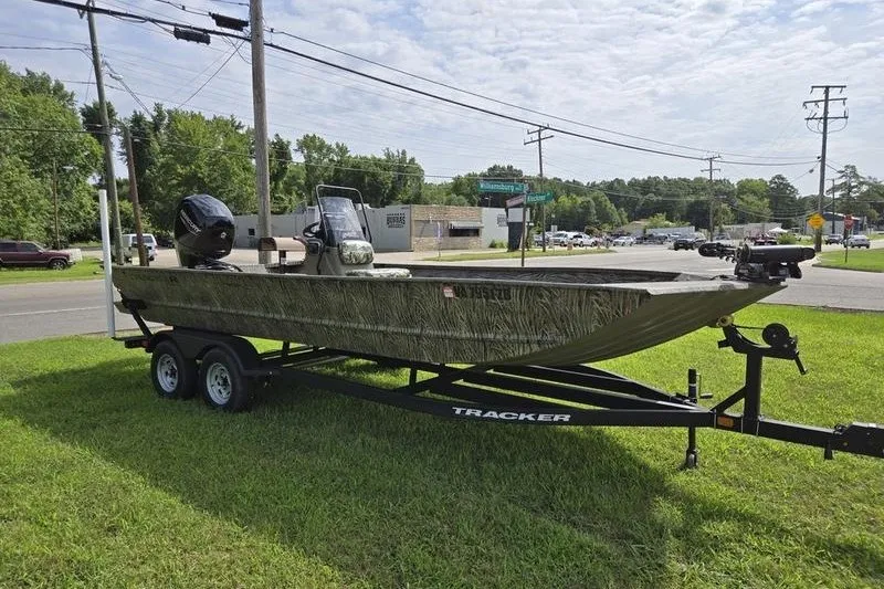 Slide: The Image of 2025 Tracker Grizzly 2072 CC boat on trailer, parked on grass near road. - 4
