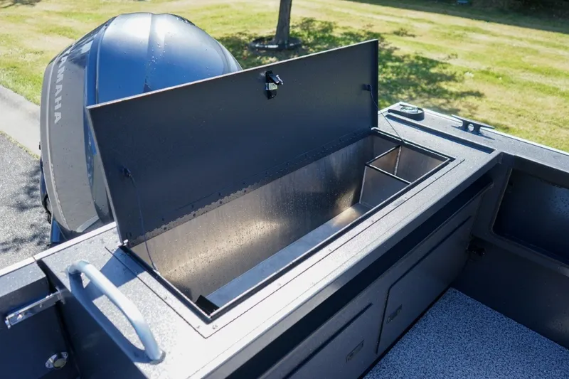 Slide: The Image of 2026 Alumaweld Intruder Outboard 22 boat with open storage compartment and Yamaha engine. - 8