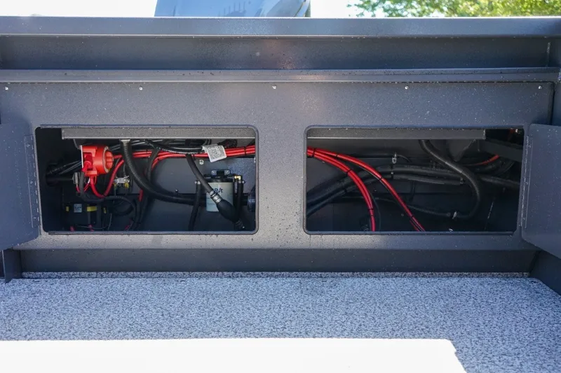Slide: The Image of 2026 Alumaweld Intruder Outboard 22 boat wiring compartment with visible cables and components. - 9