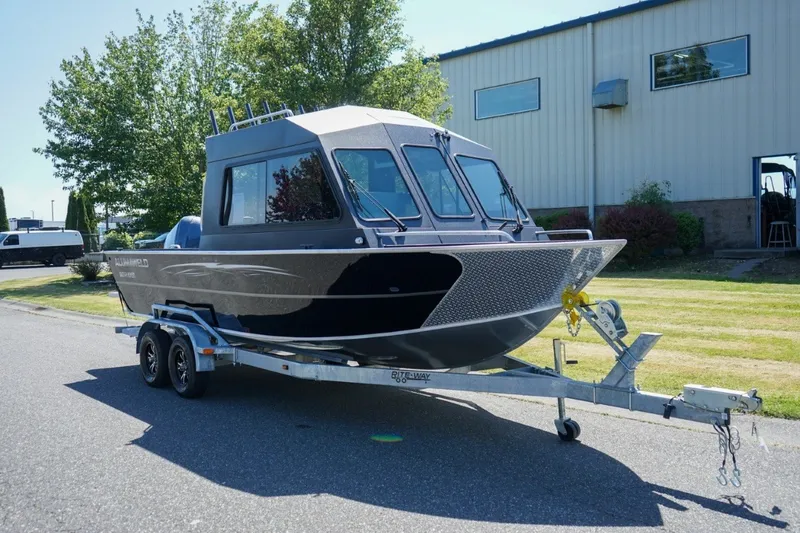 Slide: The Image of A 2026 Alumaweld Intruder Outboard 22 on a trailer in front of a building. - 12