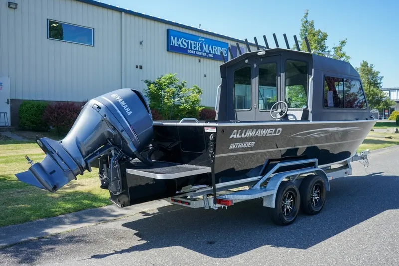 Slide: The Image of 2026 Alumaweld Intruder Outboard 22 boat with Yamaha engine on trailer, parked outside Master Marine. - 4
