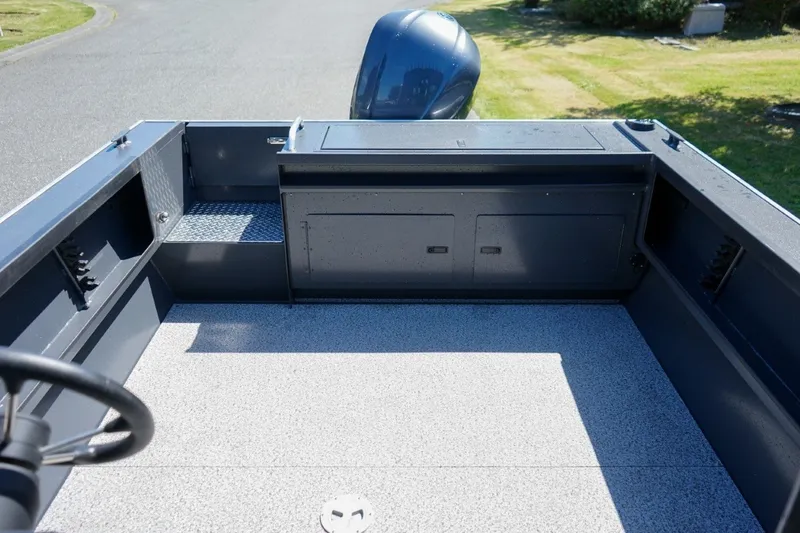 Slide: The Image of 2026 Alumaweld Intruder Outboard 22 boat interior, featuring spacious deck and storage compartments. - 7