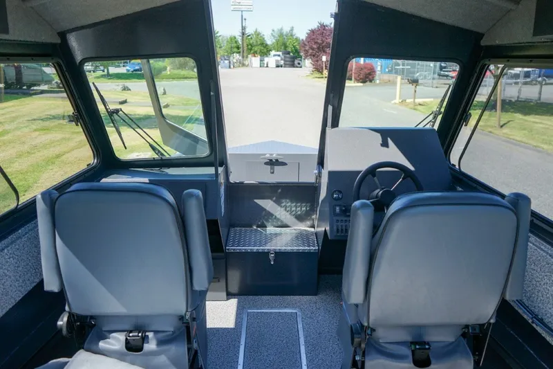 Slide: The Image of Interior view of 2026 Alumaweld Intruder Outboard 22 boat cockpit with dual seats. - 12
