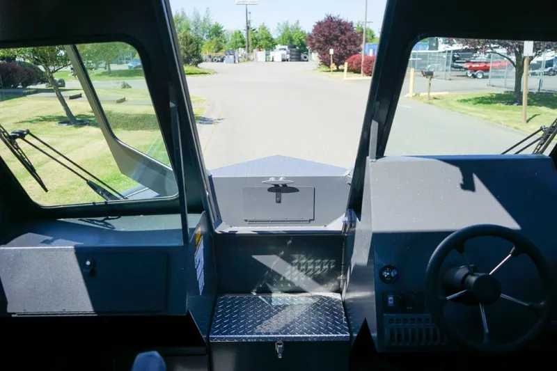 Slide: The Image of Interior view of 2026 Alumaweld Intruder Outboard 22 boat cockpit with steering wheel. - 16