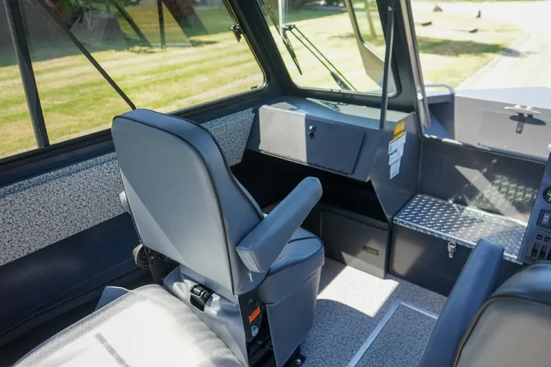 Slide: The Image of Interior of 2026 Alumaweld Intruder Outboard 22 boat, featuring modern seating and dashboard. - 15