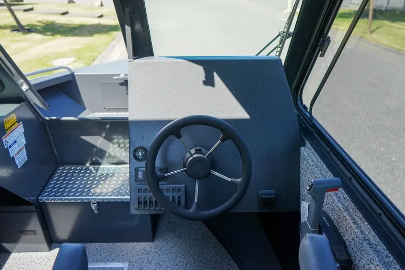 Slide: The Image of 2026 Alumaweld Intruder Outboard 22 boat dashboard with steering wheel and control panel. - 14