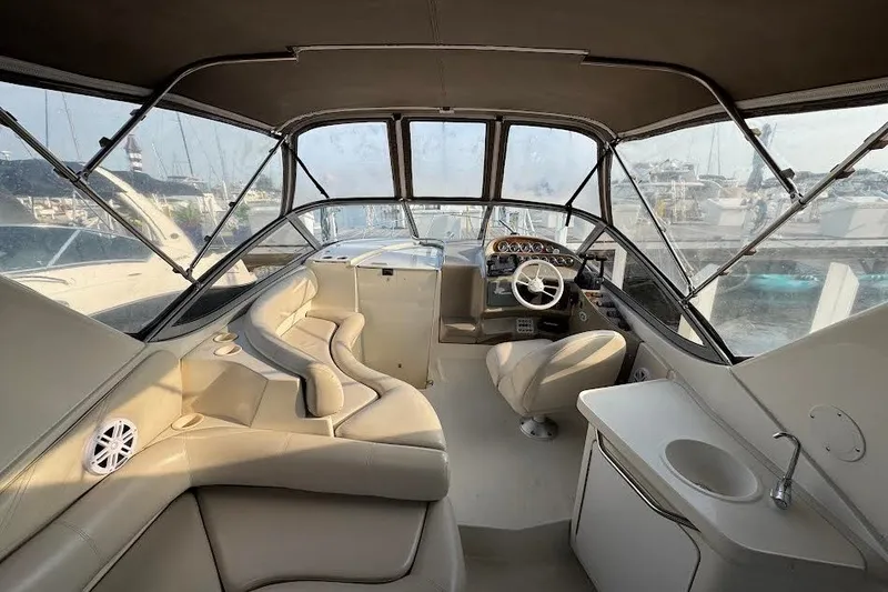 Slide: The Image of Interior of a 1998 Regal Commodore 292 boat with beige seating and steering area. - 15