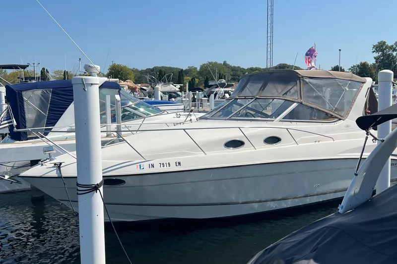 Slide: The Image of 1998 Regal 292 Commodore boat docked in a marina on a sunny day. - 2