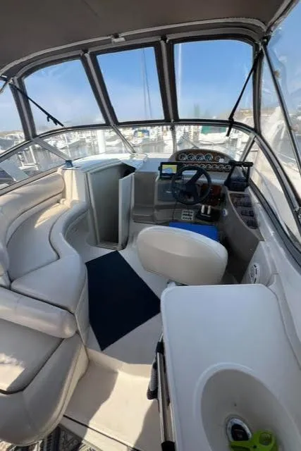 Slide: The Image of Interior of 1998 Regal 292 Commodore boat with helm and seating area. - 10