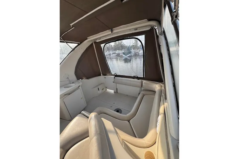 Slide: The Image of Interior of 1998 Regal Commodore 292 boat with beige seating and window view. - 16