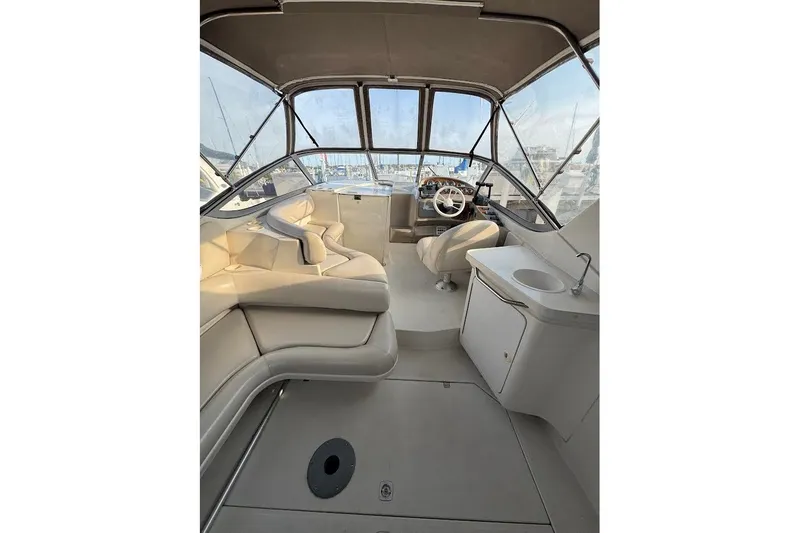 Slide: The Image of Interior of a 1998 Regal Commodore 292 boat with seating and helm. - 12