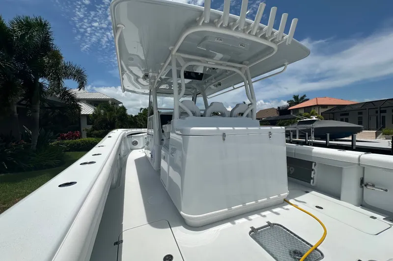 Slide: The Image of 2026 Yellowfin 39 Offshore boat with sleek design, docked under clear blue sky. - 32