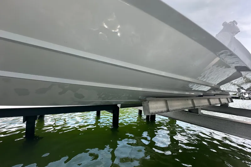 Slide: The Image of 2026 Yellowfin 39 Offshore boat hull on a lift above water. - 21