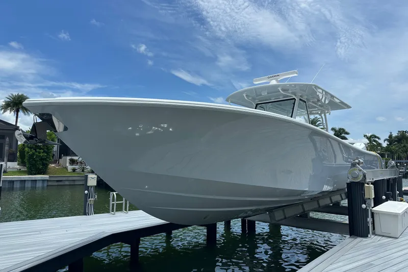 Slide: The Image of 2026 Yellowfin 39 Offshore boat docked under a clear blue sky. - 3