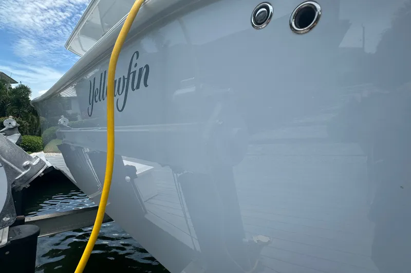Slide: The Image of 2026 Yellowfin 39 Offshore boat docked, showcasing sleek design and branding. - 10