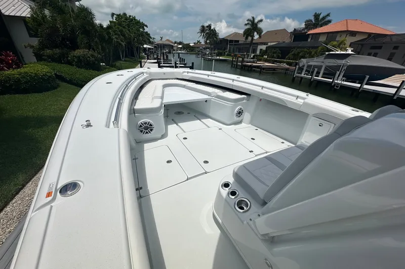Slide: The Image of 2026 Yellowfin 39 Offshore boat, spacious deck, sleek design, docked by waterfront homes. - 34