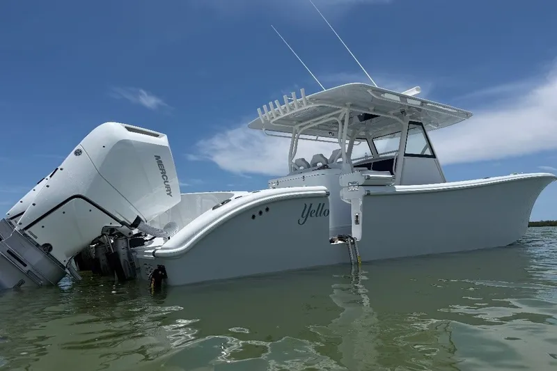 The Image of 2026 Yellowfin 39 Offshore boat with Mercury engine on calm water under blue sky. - 1