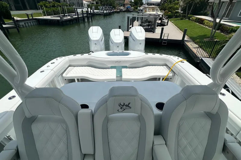 Slide: The Image of 2026 Yellowfin 39 Offshore boat interior with luxurious seating and triple outboard engines. - 44