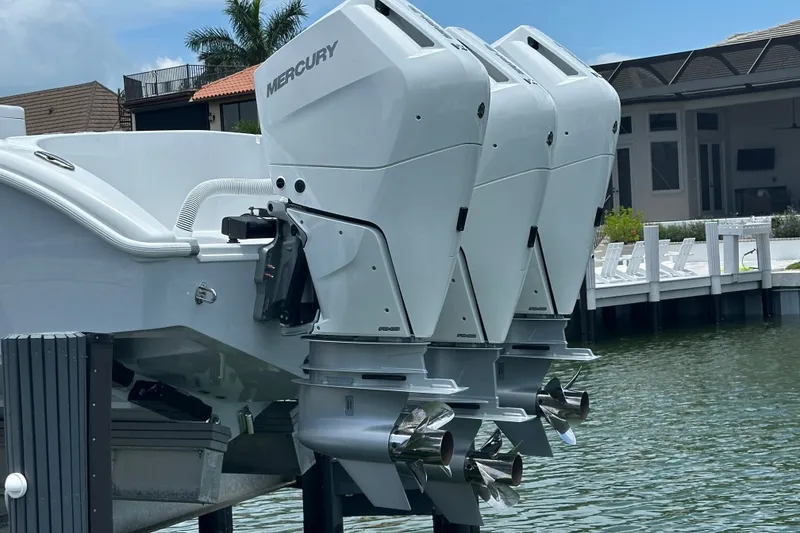 Slide: The Image of 2026 Yellowfin 39 Offshore boat with triple Mercury outboard engines docked by waterfront. - 6