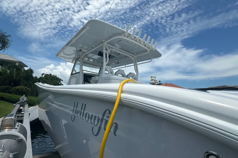 Slide: The Image of 2026 Yellowfin 39 Offshore boat docked under a partly cloudy sky. - 11