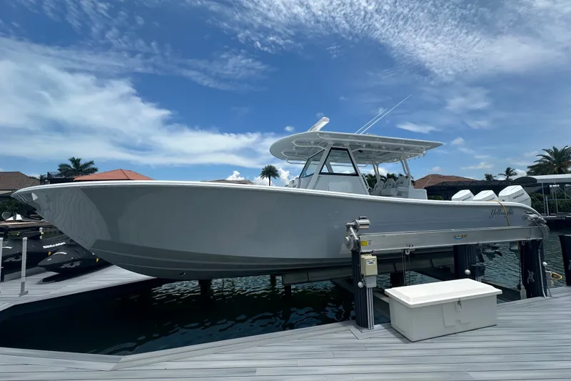Slide: The Image of 2026 Yellowfin 39 Offshore boat docked under a clear blue sky. - 4