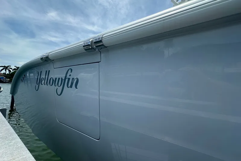 Slide: The Image of 2026 Yellowfin 39 Offshore boat docked, showcasing sleek design and branding. - 19