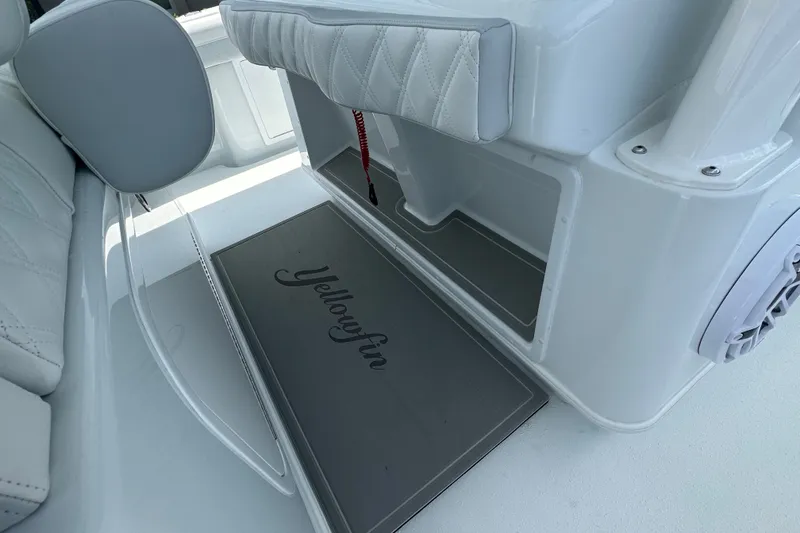 Slide: The Image of 2026 Yellowfin 39 Offshore boat interior with cushioned seating and branded flooring. - 43