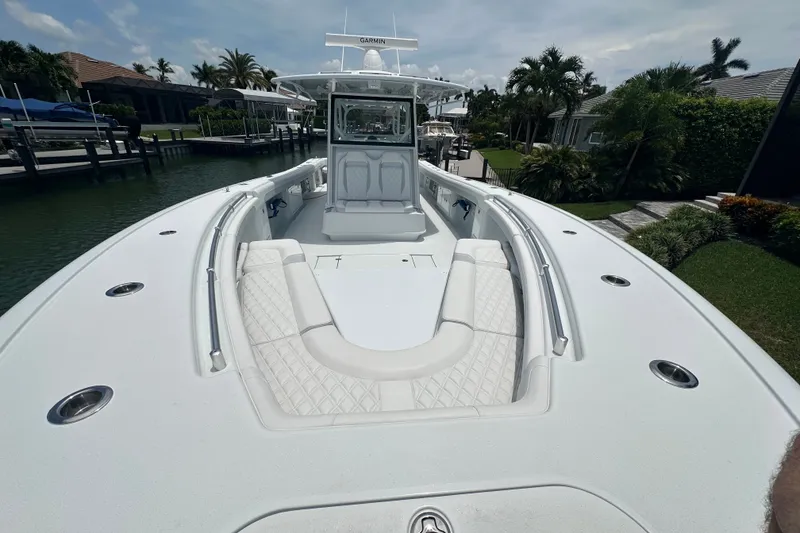 Slide: The Image of 2026 Yellowfin 39 Offshore boat with spacious deck and luxurious seating in a marina setting. - 24