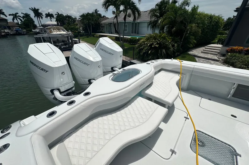 Slide: The Image of 2026 Yellowfin 39 Offshore boat with triple Mercury engines, docked by a waterfront property. - 30