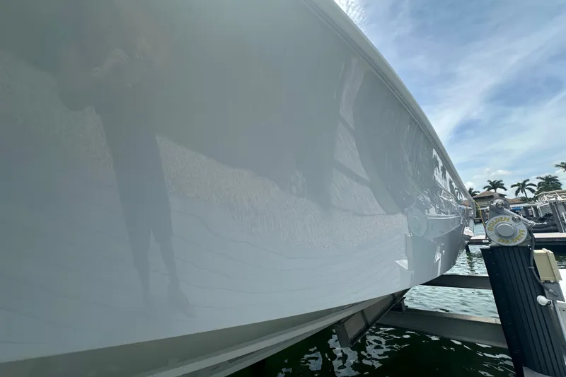 Slide: The Image of 2026 Yellowfin 39 Offshore boat on lift, reflecting sky and surroundings. - 12