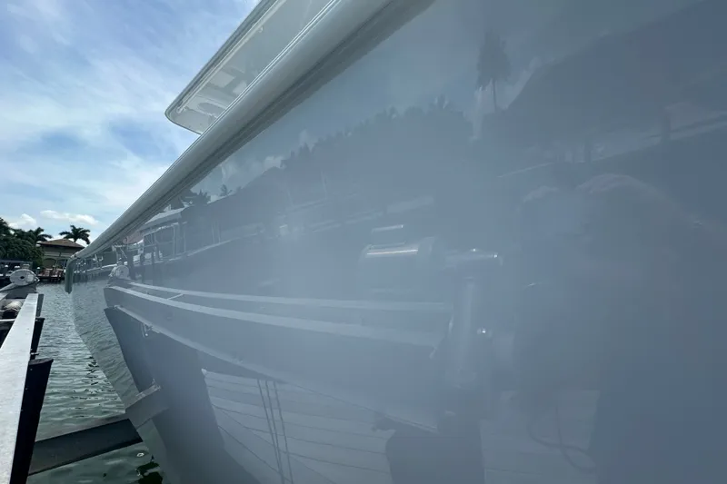 Slide: The Image of 2026 Yellowfin 39 Offshore boat reflecting on calm water under a clear sky. - 18