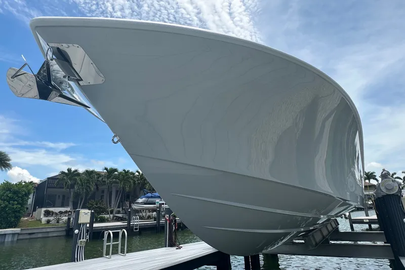 Slide: The Image of 2026 Yellowfin 39 Offshore boat docked, showcasing sleek hull design under a clear blue sky. - 13